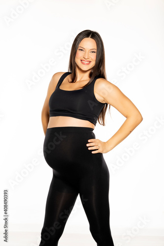 a pregnant happy young woman posing in black leggings and a shirt © vladimirfloyd