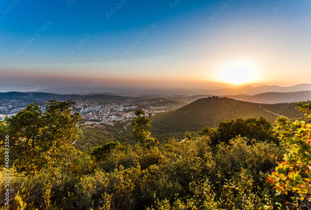 Romantic evening atmosphere at dusk: view of a Greek city at sunset