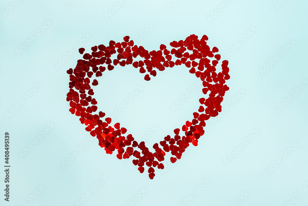 A big heart laid out of small hearts on a blue background, a romantic background and a place for text