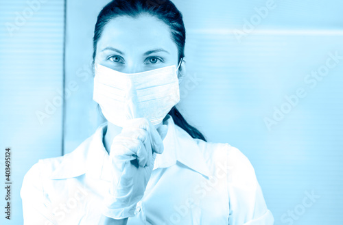 nurse in medical mask gesture and asking to be quiet with finger on lips