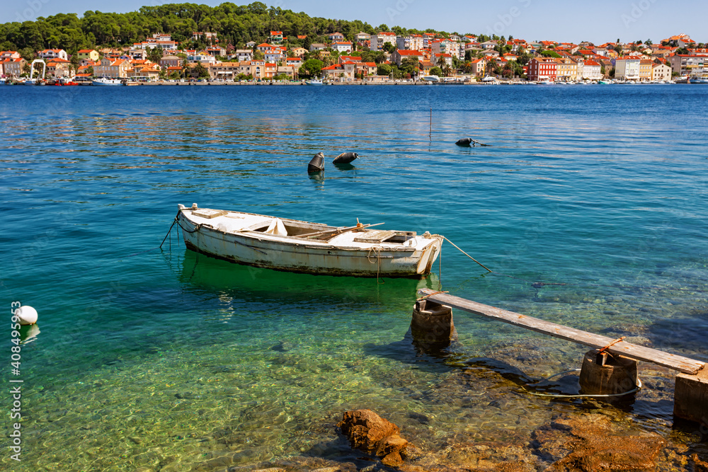 boat moored at the wooden pier in harbour of Losinj town, Croatia. boat moored at the wooden pier in harbour of Losinj town, Croatia.