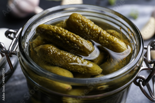 Glass jar of tasty pickled cucumbers, closeup