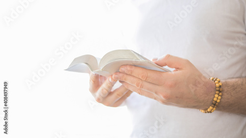 The Christian holds the Bible in his hands. Reading the bible. The concept of faith, spirituality and religion