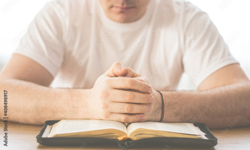 Reading the bible. Prayer. Hands folded in prayer concept. The concept of faith, spirituality and religion Reading the bible. Prayer. Hands folded in prayer concept. The concept of faith, spirituality and religion