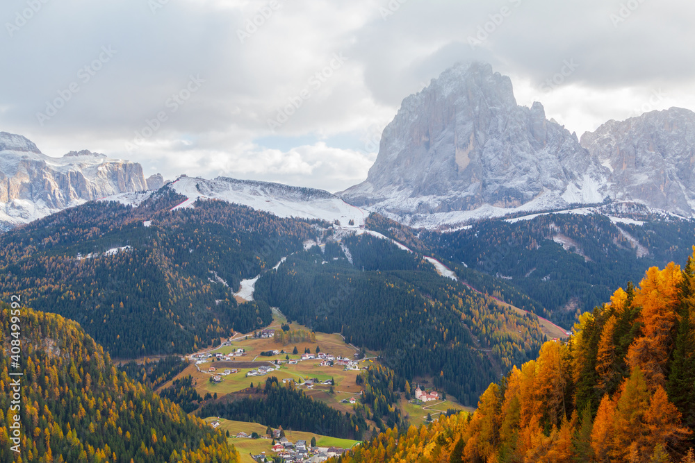 Typical mountain landscape with views of the Sella mountain groups and the Sassolungo mountain range (Langkofel), Dolomites at sunset, South Tyrol Typical mountain landscape with views of the Sella mountain groups and the Sassolungo mountain range (Langkofel), Dolomites at sunset, South Tyrol
