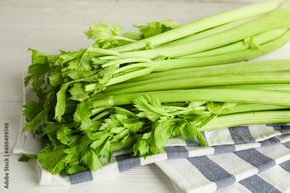 Fresh ripe green celery on white wooden table Fresh ripe green celery on white wooden table