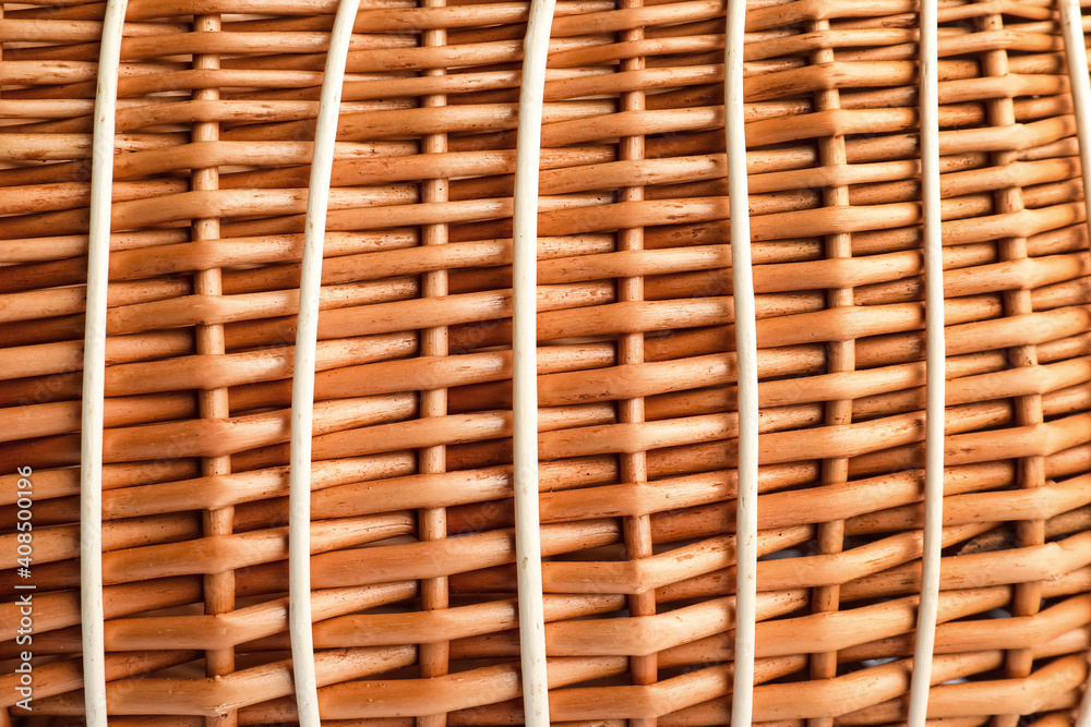 Handmade wicker basket made of natural material as background, closeup view Handmade wicker basket made of natural material as background, closeup view