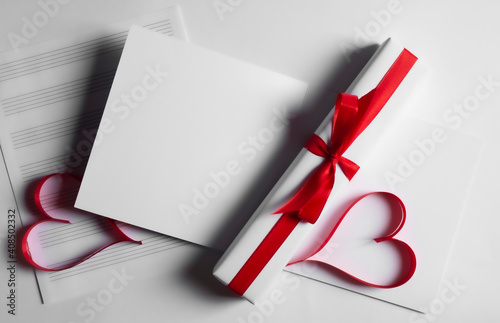 Postcard , gift box  with red ribbon and hearts on white background.14 February Valentine's day.Copy space.