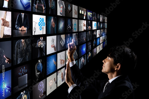 фотографія Asian businessman editing a lot of images