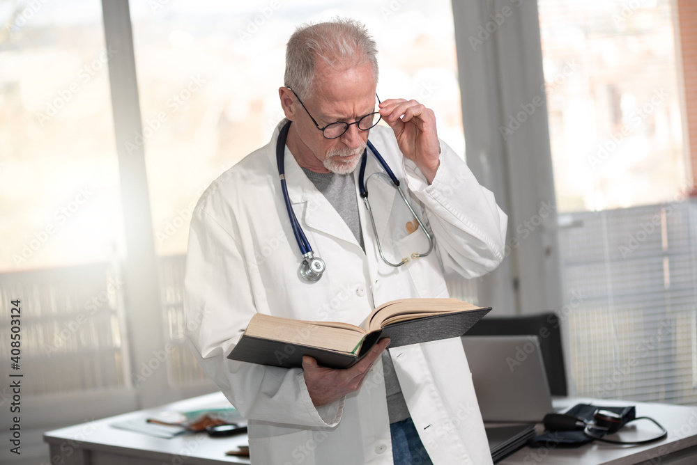 Doctor reading a textbook