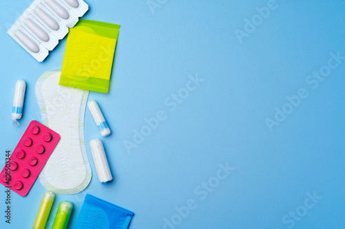 Female hygienic pad and tampons on blue background