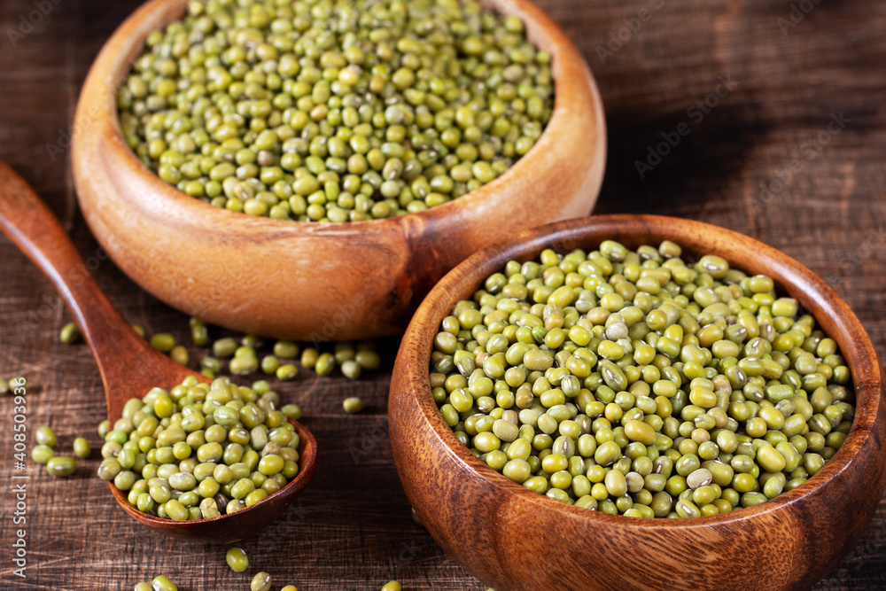 Mung. Green mung beans in a bowl on a brown wooden table. Legume plant for a healthy diet Mung. Green mung beans in a bowl on a brown wooden table. Legume plant for a healthy diet