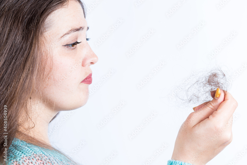 Lost hair in hand. Girl with hair problem on a white. Lost hair in hand. Girl with hair problem on a white.