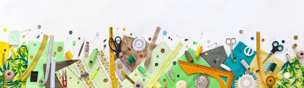 Spring sewing and home needlework. Panoramic top view on green and yellow pieces of fabric, and sewing accessories on white background. Flat lay, copy space, closeup, banner, mock up - obrazy, fototapety, plakaty 