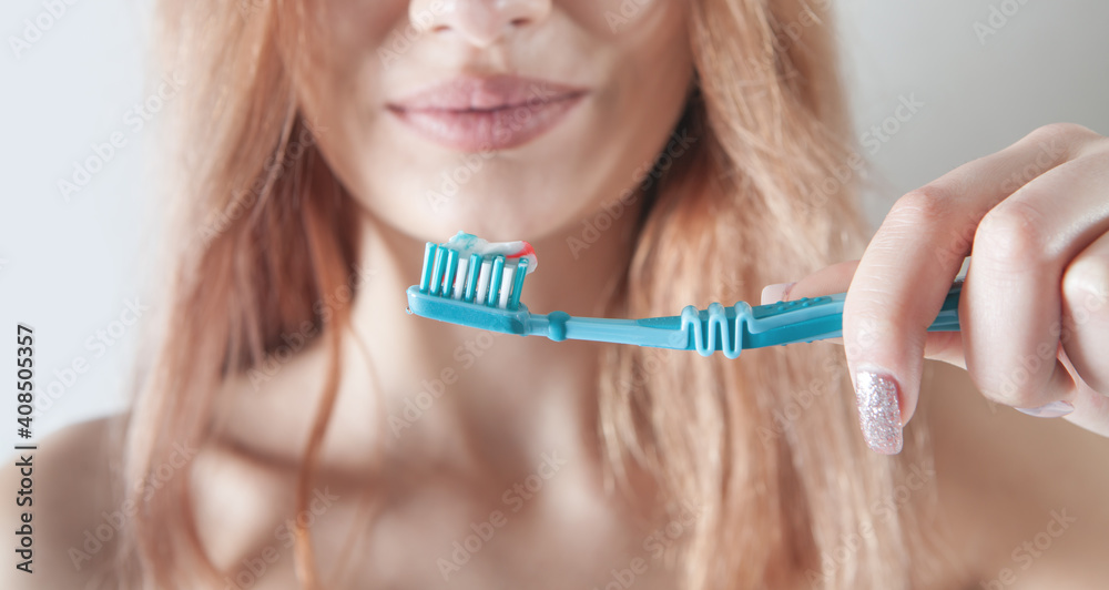 Young woman holding toothbrush before brushing teeth. Young woman holding toothbrush before brushing teeth.