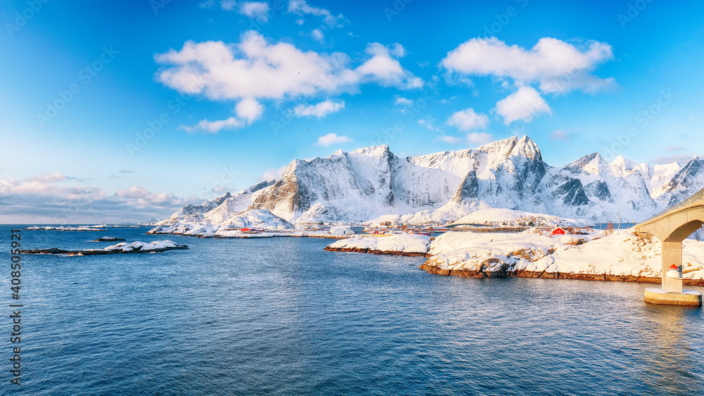 Fabulous winter view of Reine and Sakrisoya villages  seen from Hamnoy and snowy mountaines in background .