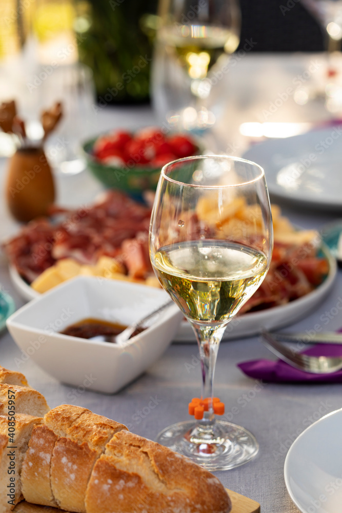 Set up table with white wine and appetizers