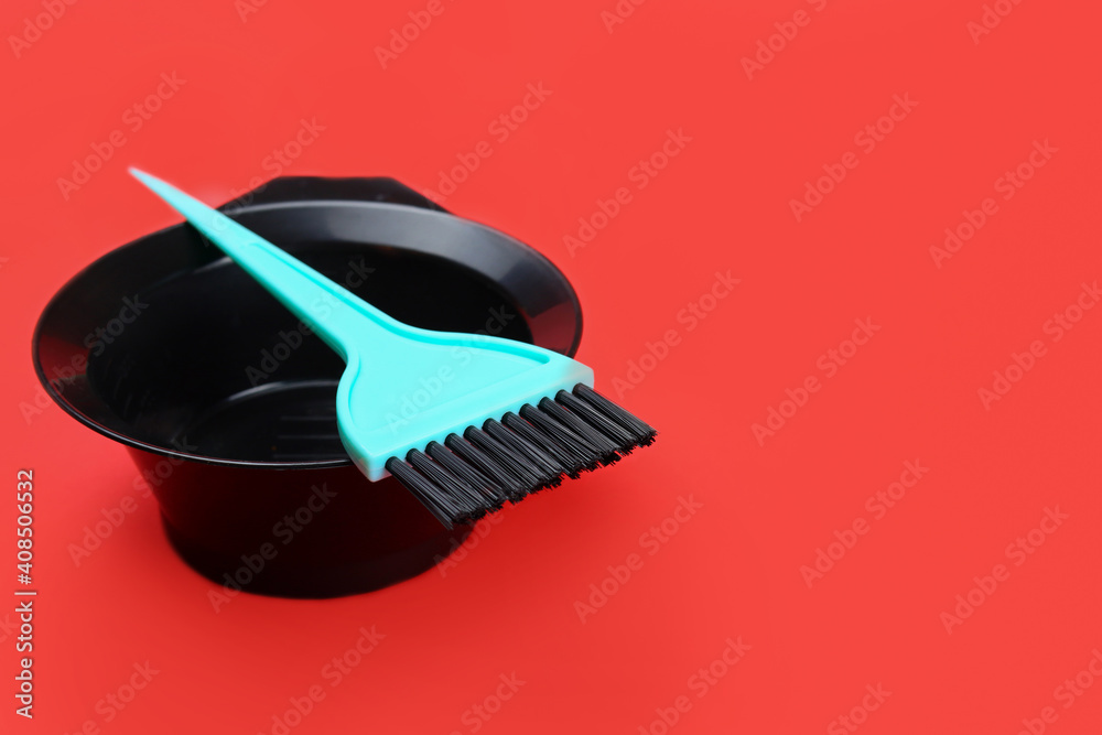 Hair dye bowl and brush on red background Stock Photo | Adobe Stock