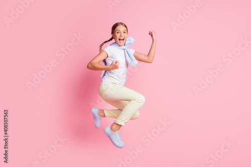 Full body profile side photo of young girl happy excited jump um celebrate victory fists hands isolated over pastel color background