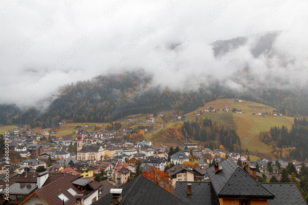 Foggy weather in Ortisei (St. Ulrich) in beautiful autumn colors, Trentino-Alto Adige, Bolzano province in South Tyrol