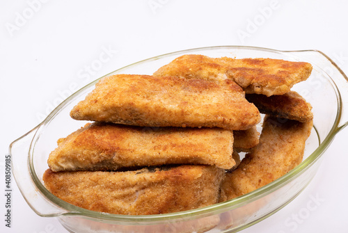 Breaded fish fillets in a glass, heat-resistant dish