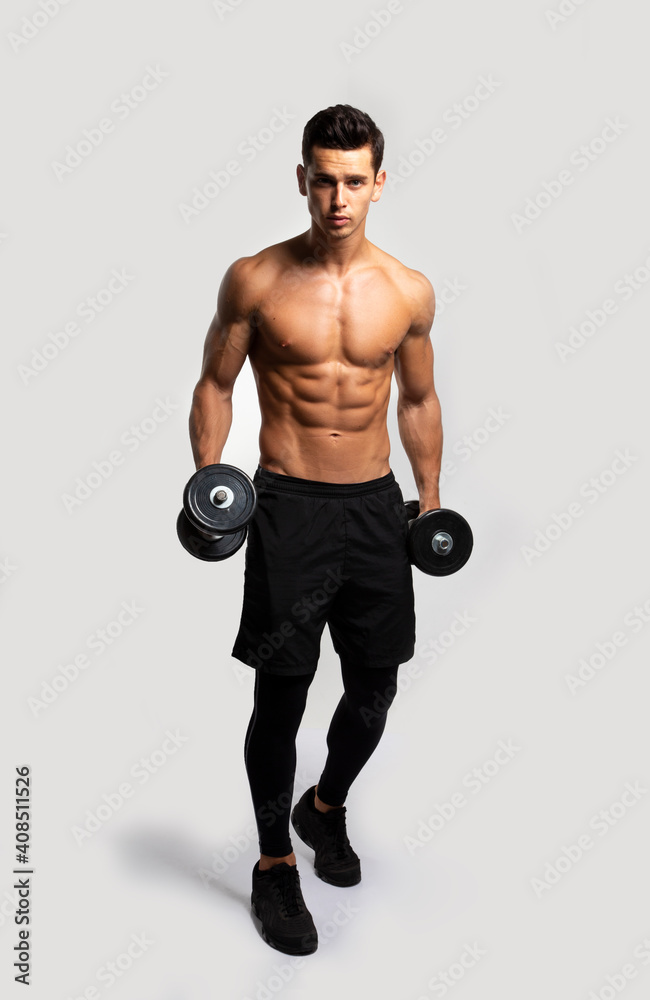 Full length image of a confident young man shirtless torso portrait training with dumb-bell, isolated white background. Full length image of a confident young man shirtless torso portrait training with dumb-bell, isolated white background.
