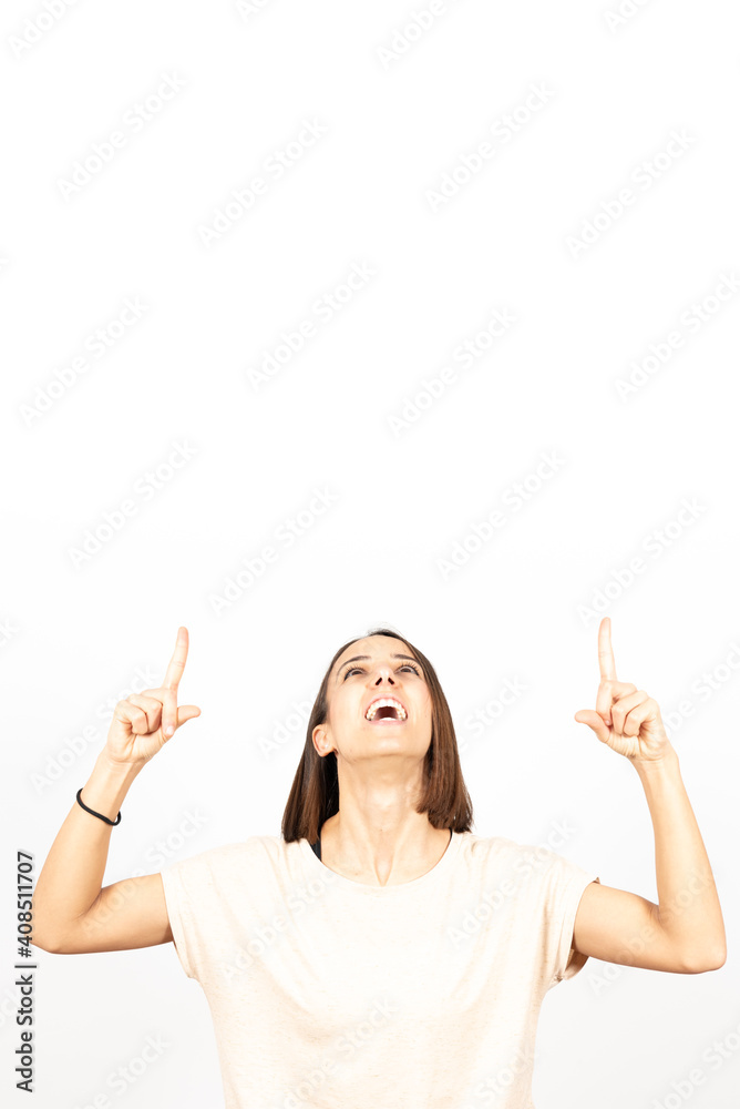 Pretty smiling hispanic girl pointing up to white copy space Pretty smiling hispanic girl pointing up to white copy space