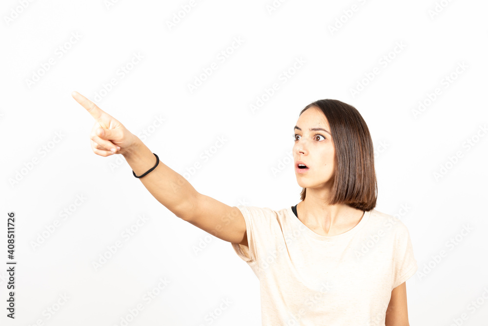 Pretty hispanic amazed girl pointing something Pretty hispanic amazed girl pointing something