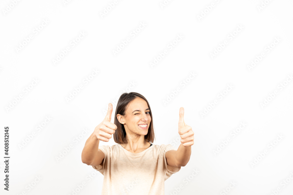 A latin girl winking while holding the thums up. A latin girl winking while holding the thums up.