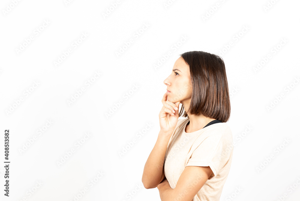 A brunette hispanic woman thinking on an idea with serious gesture and looking to copy space. A brunette hispanic woman thinking on an idea with serious gesture and looking to copy space.