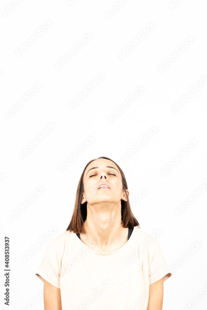 A tired latin woman looking up in relaxing or meditation posture to copy space. A tired latin woman looking up in relaxing or meditation posture to copy space.