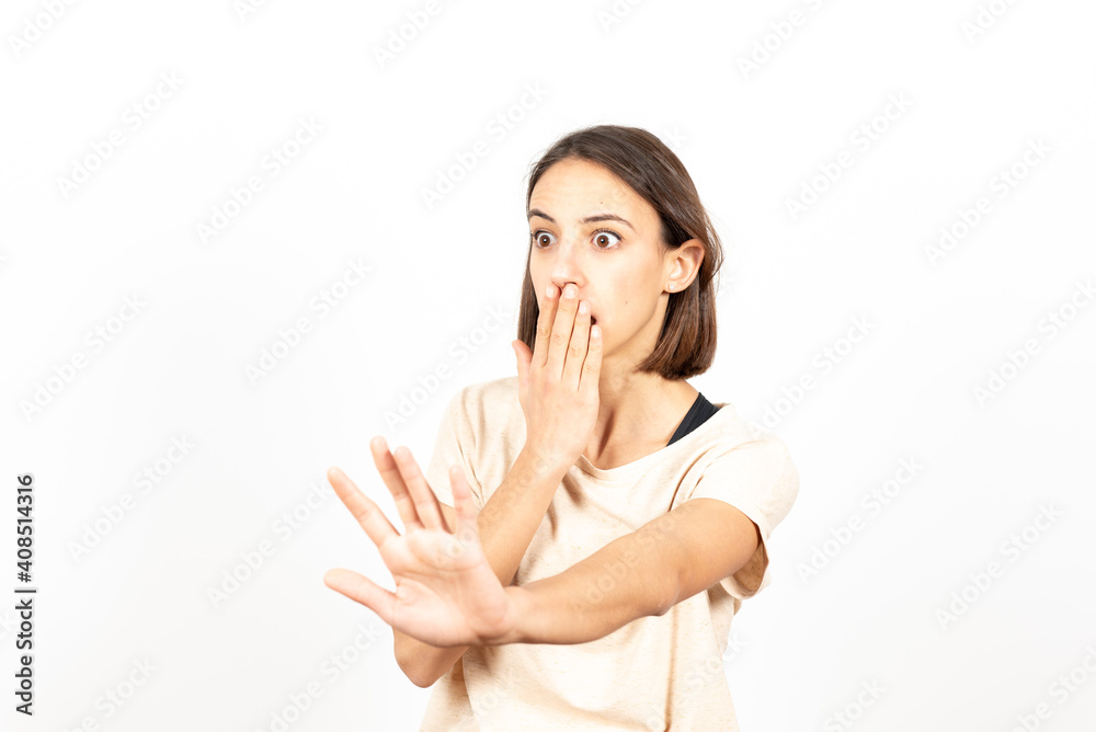 A latin woman covering her mouth and regreting something she has told asking for forgiveness A latin woman covering her mouth and regreting something she has told asking for forgiveness