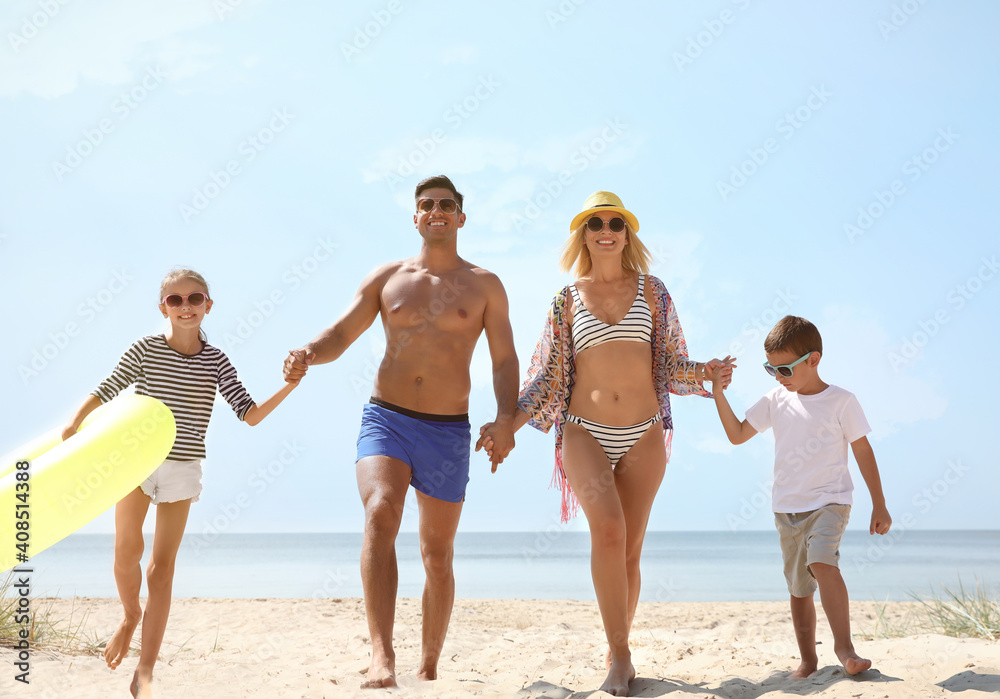 Family with inflatable ring at beach on sunny day Family with inflatable ring at beach on sunny day