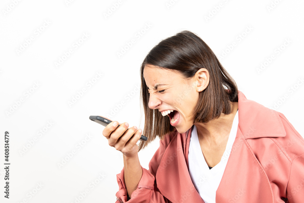 Angry latin woman screaming to her cell phone. Angry latin woman screaming to her cell phone.