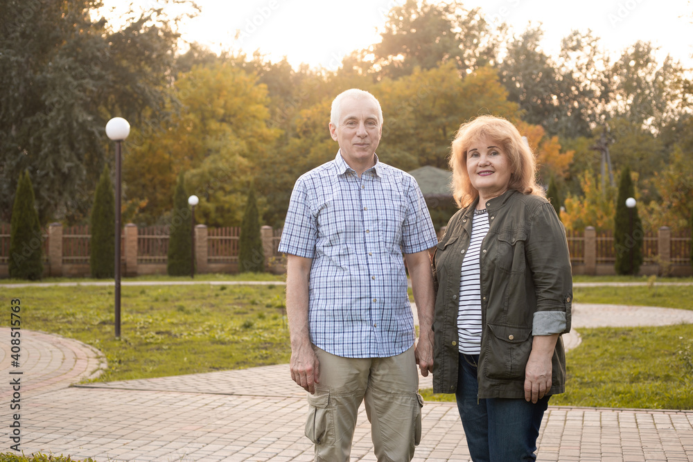Happy elderly seniors couple in summer park, Valentines day Happy elderly seniors couple in summer park, Valentines day