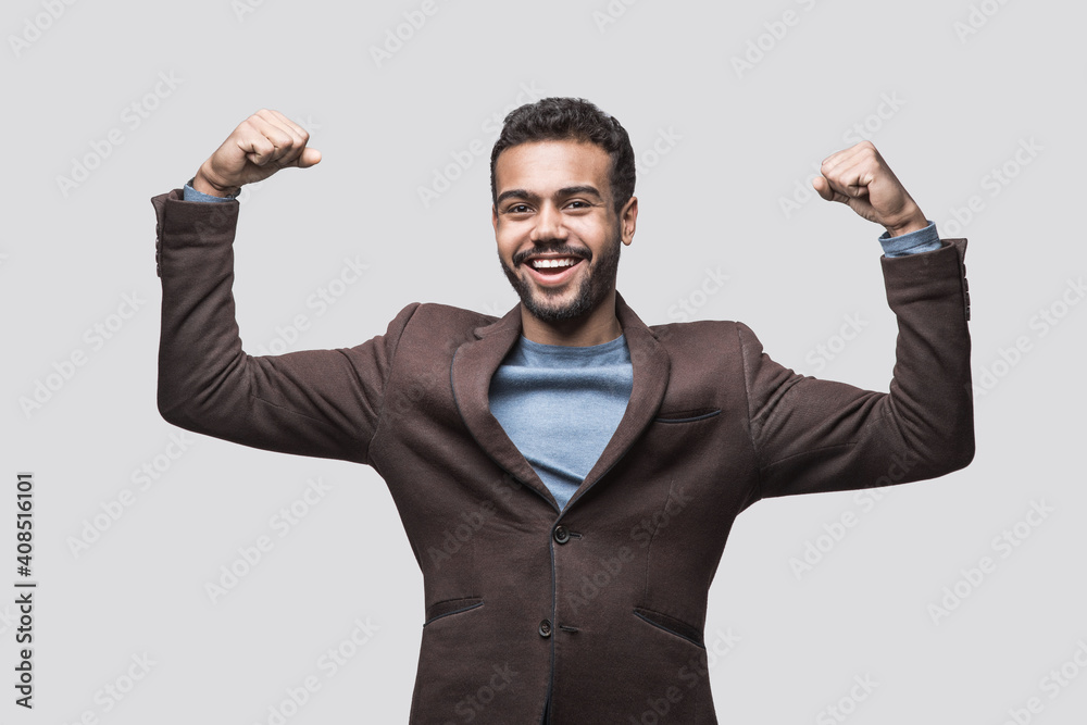 Portrait of handsome smiling young man showing strength, Powerful laughing joyful cheerful men studio shot isolated on white background Portrait of handsome smiling young man showing strength, Powerful laughing joyful cheerful men studio shot isolated on white background
