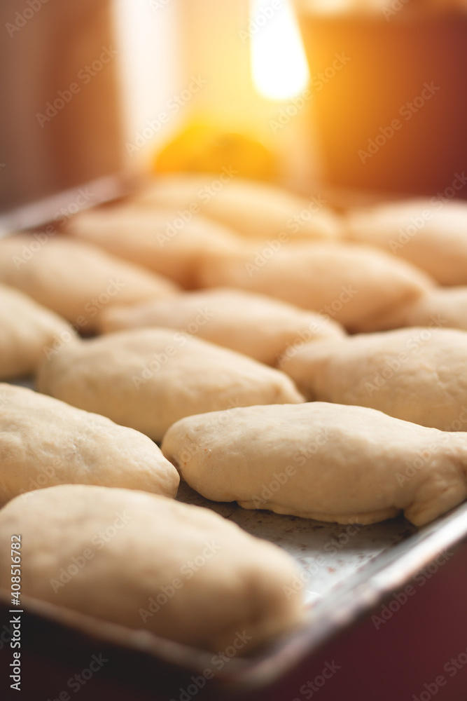 Grandma's apple pies on a baking sheet, before baking, sweet buns Grandma's apple pies on a baking sheet, before baking, sweet buns