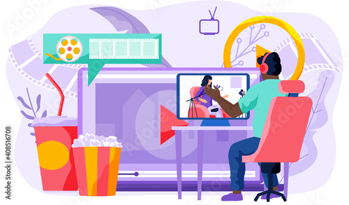 The guy in the headphones looks at the singing girl on the monitor. Online cinema concept. Male character near big screen with popcorn bucket and drinks. Watch movie online. Man working from home