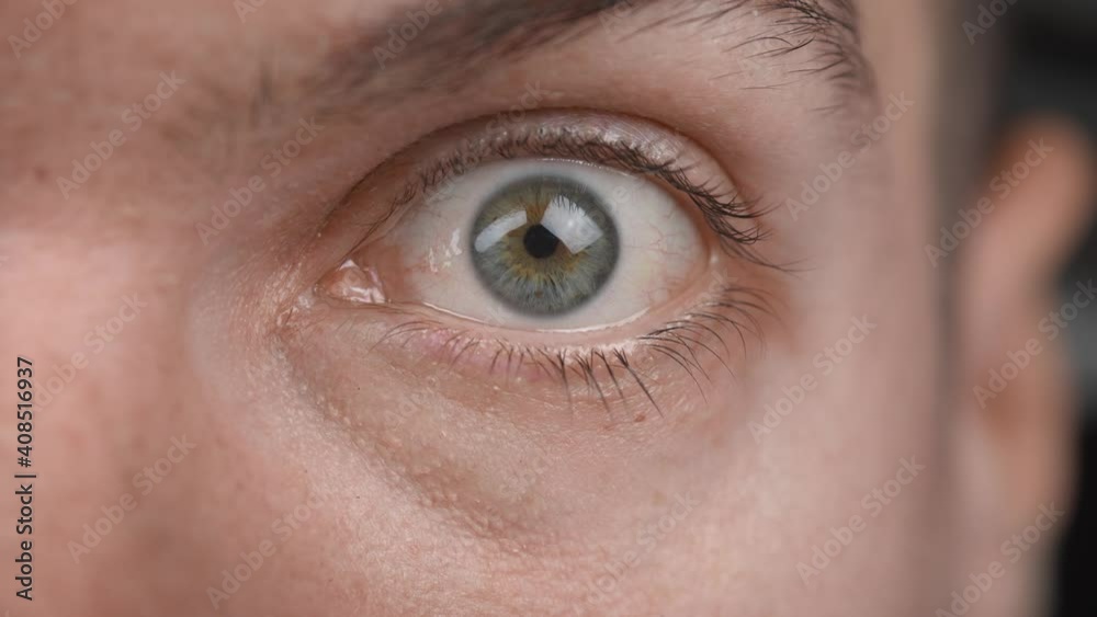 Extreme close up of surprised male opens his eye wide and stares at the camera. Scared man shock reaction macro eye. Extreme close up of surprised male opens his eye wide and stares at the camera. Scared man shock reaction macro eye.