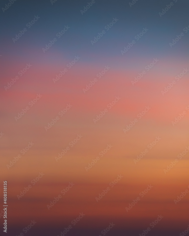 Smooth gradient of the evening sky with dramatic sunset colors. Colorful background texture. Clear sky. Pink, orange, yellow and blue colors. No clouds. Beautiful soft light. Twilight Nightfall Night 