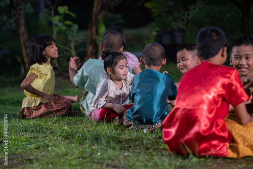Group of Asian children in traditional costumes playing outdoor activities. local traditional game in Thai culture concept. 