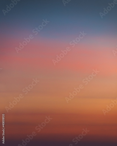 Smooth gradient of the evening sky with dramatic sunset colors. Colorful background texture. Clear sky. Pink, orange, yellow and blue colors. No clouds. Beautiful soft light. Twilight Nightfall Night 