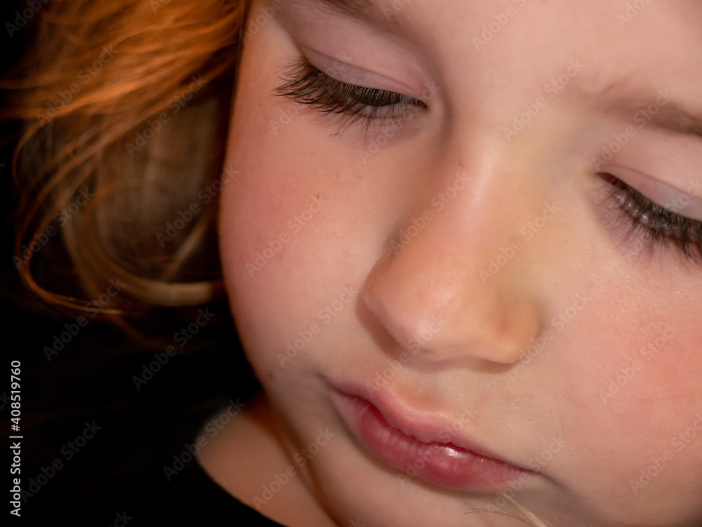 Fototapeta premium Close-up of a preschool girl using a mobile phone