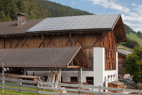 Rural scene of an alpine barn with photovoltaic panels © TPhotography