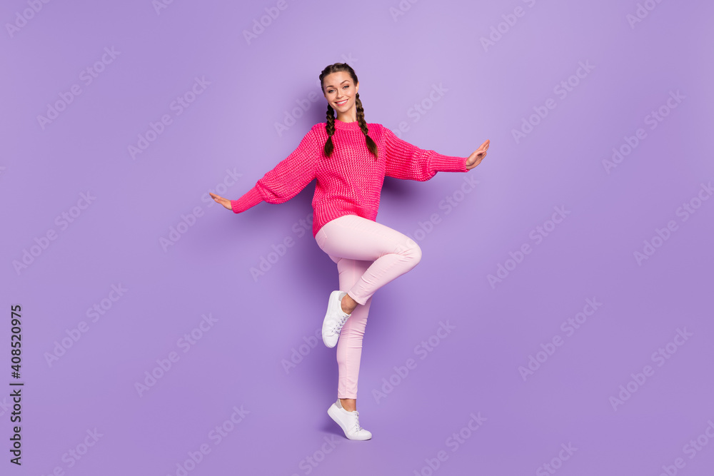 Full length photo of stunning happy charming woman raise palms wear pink sweater trousers isolated on purple color background