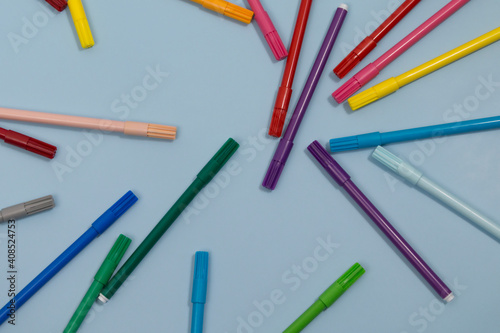 Multicolored Felt-Tip Pens isolated on a blue background © OlgaFet
