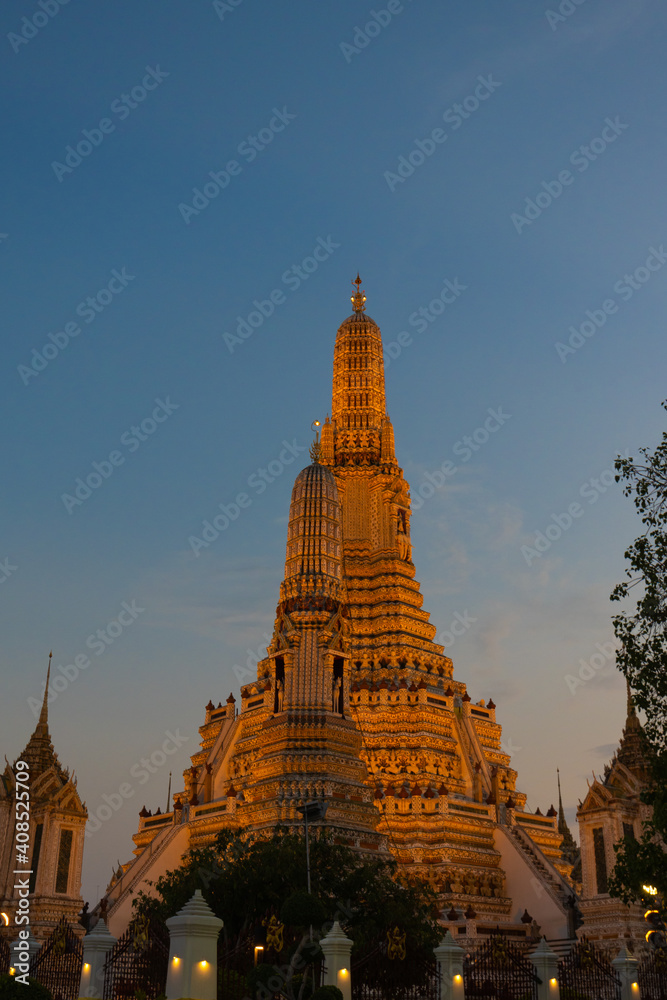 Illuminated Wat Arun Temple in sunset. Buddhist temple in Bangkok, Thailand. Vertical orientation Illuminated Wat Arun Temple in sunset. Buddhist temple in Bangkok, Thailand. Vertical orientation