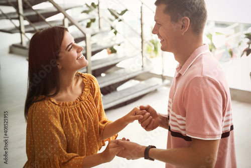 Man and woman having conversation in hall