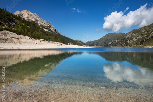 Fototapeta Naklejka Na Ścianę i Meble -  Breathtaking panorama of the Fedaia pass dam in the Dolomites. Border between Trentino Alto Adige and Veneto