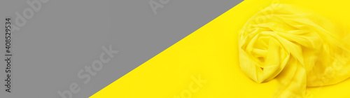 The trendy color of 2021. Bright yellow and perfect gray. Beautiful of tulle fabric on abstract background. elegant wallpaper design. Copy space, flat lay.